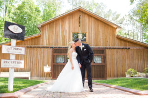 Bride and Groom kissing at The Wheeler House Barn